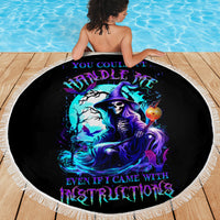 Black round beach blanket with white fringe, witch skull graphic with purple-blue colors