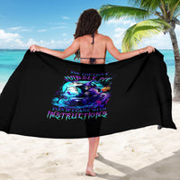 Black sarong with colorful witch skull graphic and decorative text, worn bikini-style