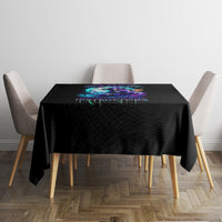 Black tablecloth with centered colorful skull drip design on square dining table
