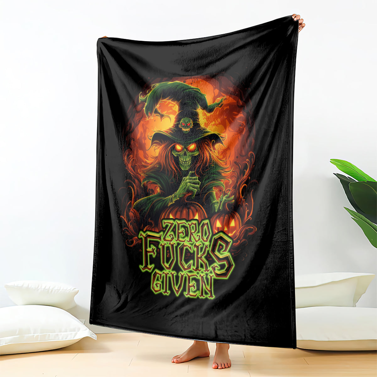 Black skull graphic blanket draped vertically, “Zero Fucks Given” front print