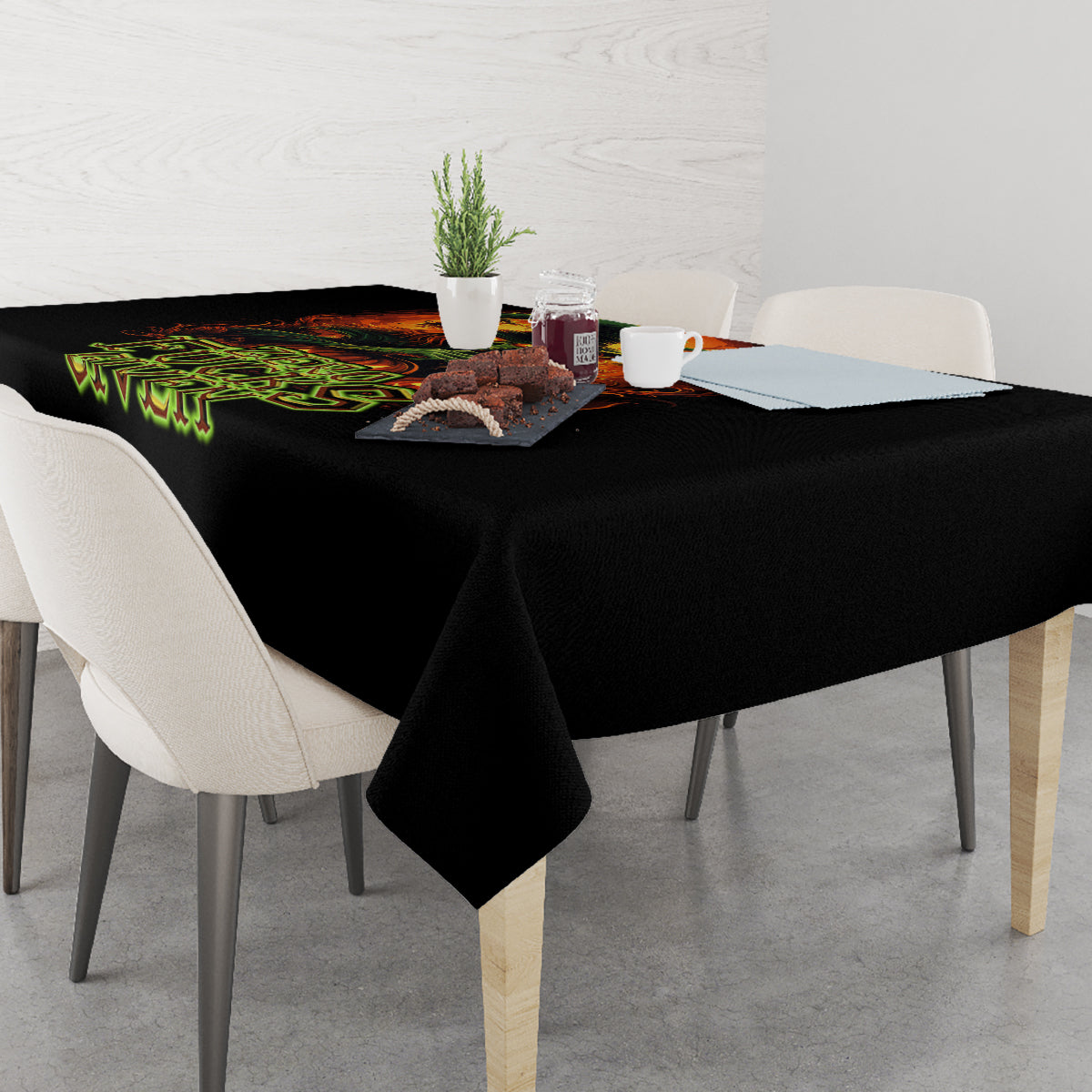 Black tablecloth draped on dining table with fiery skull and green “Zero F**ks Given”
