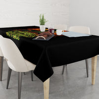 Black tablecloth draped on dining table with fiery skull and green “Zero F**ks Given”