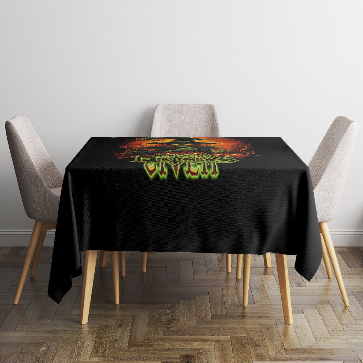 Black tablecloth on square table with fiery skull graphic and green “Zero F**ks Given”