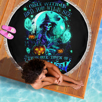 Round black Halloween beach blanket with blue witch skull graphic and white fringe edge