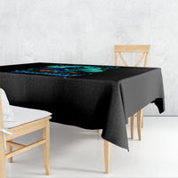 Black tablecloth with teal witch skull graphic on tabletop