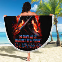 Round black beach blanket with skull warrior print and white fringe edging, 150 cm