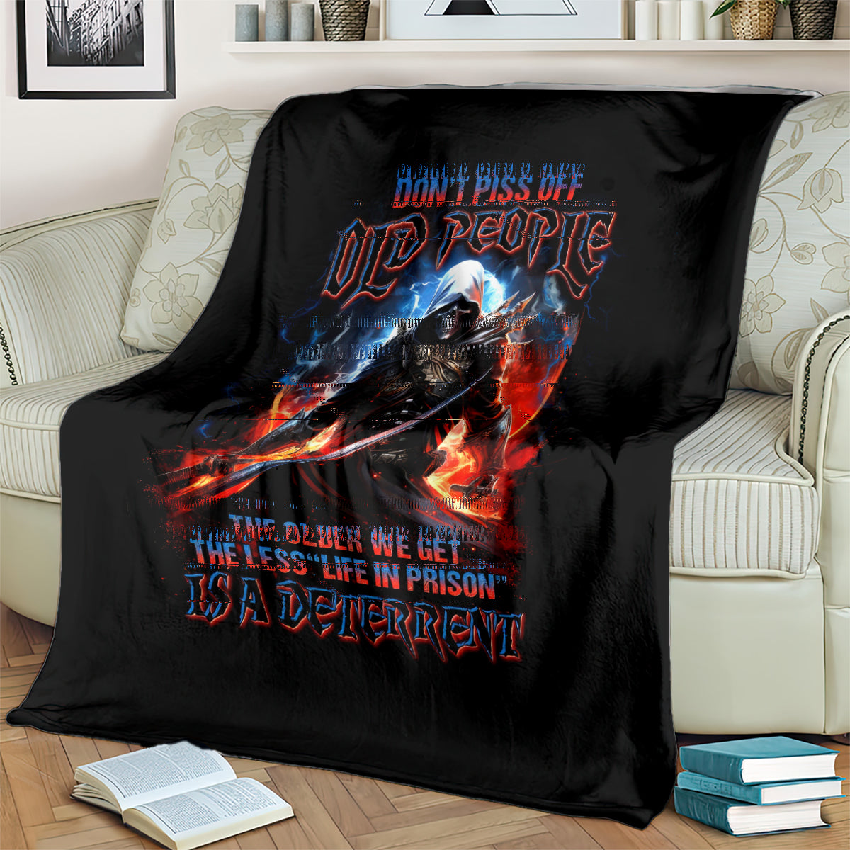 Black warrior skull blanket draped over couch, fiery sword and blue-red lettering