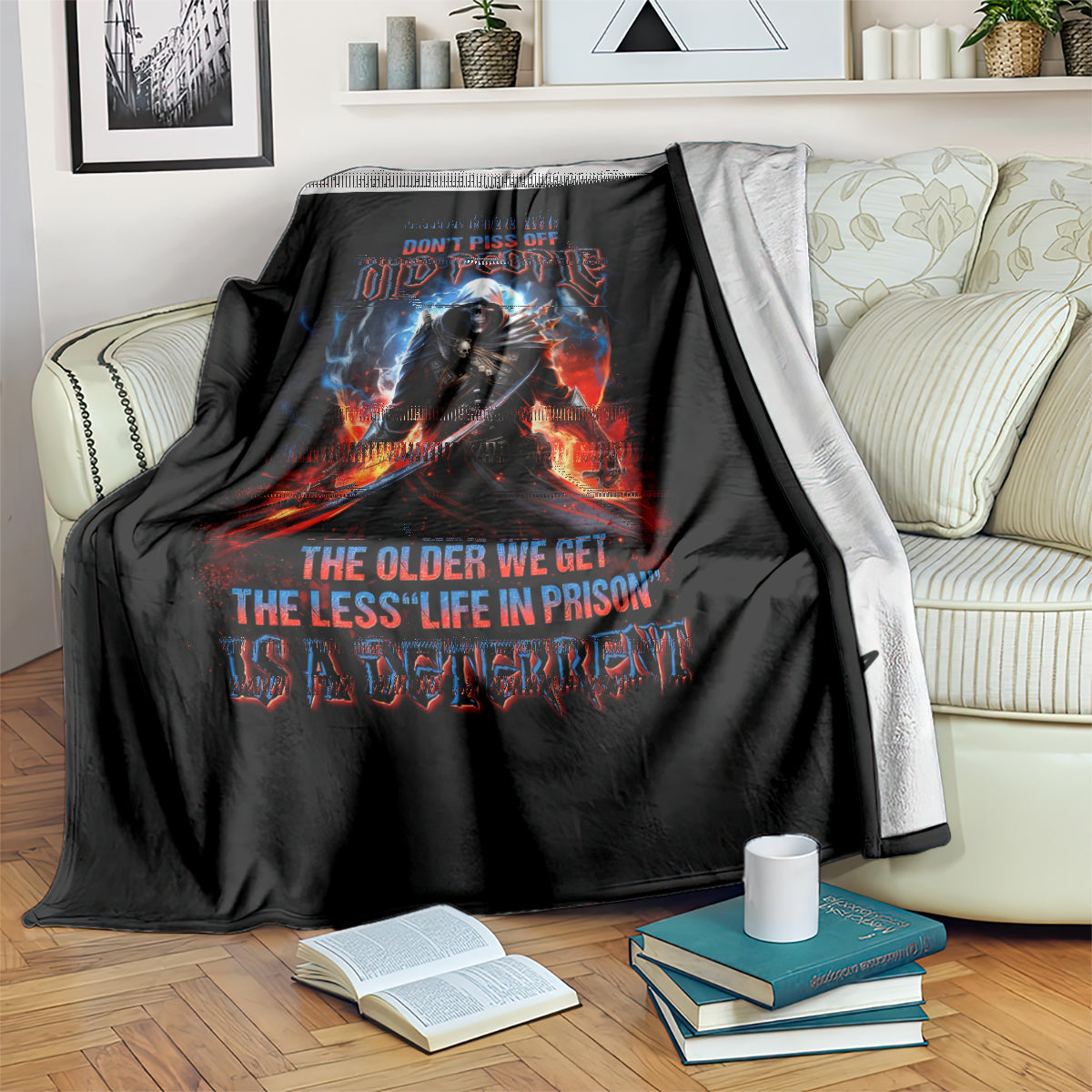 Black graphic blanket on sofa with warrior skull, flames, and quote text