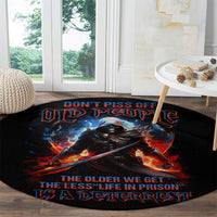 Black round carpet with warrior skull graphic and “Don’t piss off old people” text