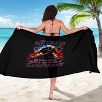 Black warrior skull sarong with fiery graphic, worn as a beach wrap