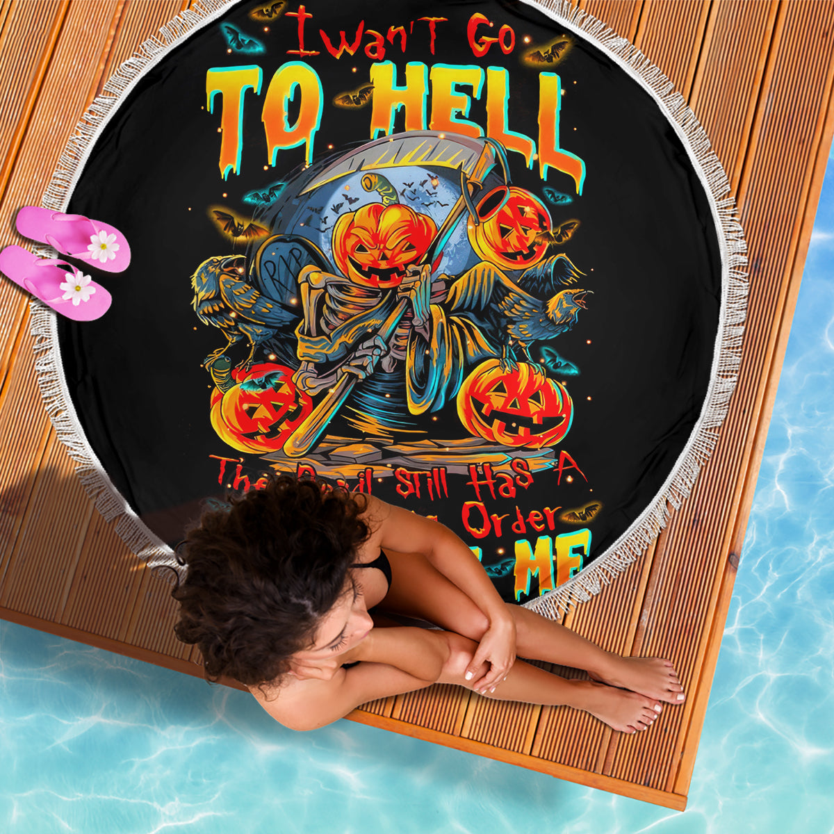 Black round beach blanket with devil skull pumpkin graphic and white fringe edge