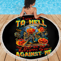 Black round beach blanket, devil pumpkin skull graphic centered with white fringe
