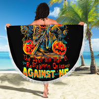 Black round beach blanket held open, devil pumpkin skull graphic and white fringed edge