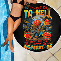 Black round beach blanket draped by model, devil pumpkin skull graphic with white fringe
