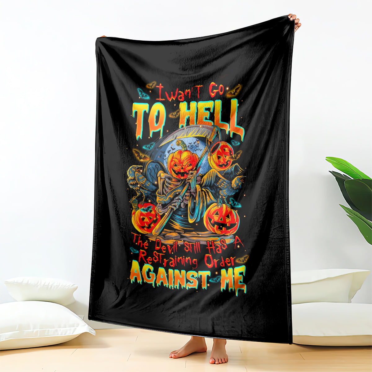 Black rectangular throw blanket showing pumpkin skull skeleton with “TO HELL” and “AGAINST ME”.