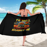 Black sarong with colorful skull and pumpkin graphic, worn as wide beach wrap