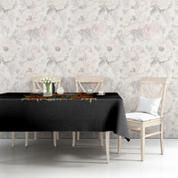 Black tablecloth with a colorful dripping strip and a draped corner on a dining table.