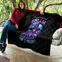 Black quilt blanket with quilted diamond pattern and purple-blue witch skull design, draped