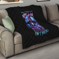 Black quilt blanket with quilted diamond pattern and purple-blue witch skull design on couch