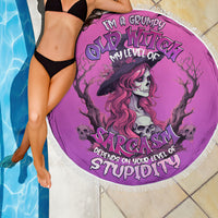 Pink round beach blanket with fringe, witch skull design and “Sarcasm” lettering
