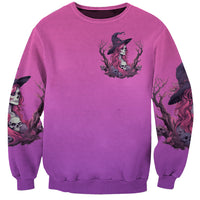 Pink sweatshirt with small witch figure skull graphic and printed sleeves, crew neck