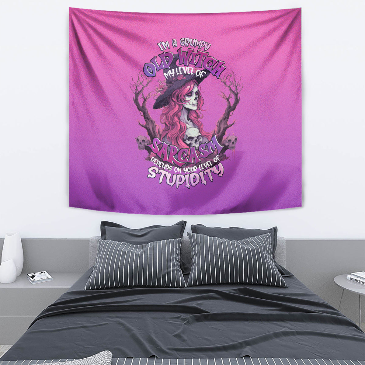 Pink witch skull tapestry with grumpy sarcastic lettering, hanging on a wall