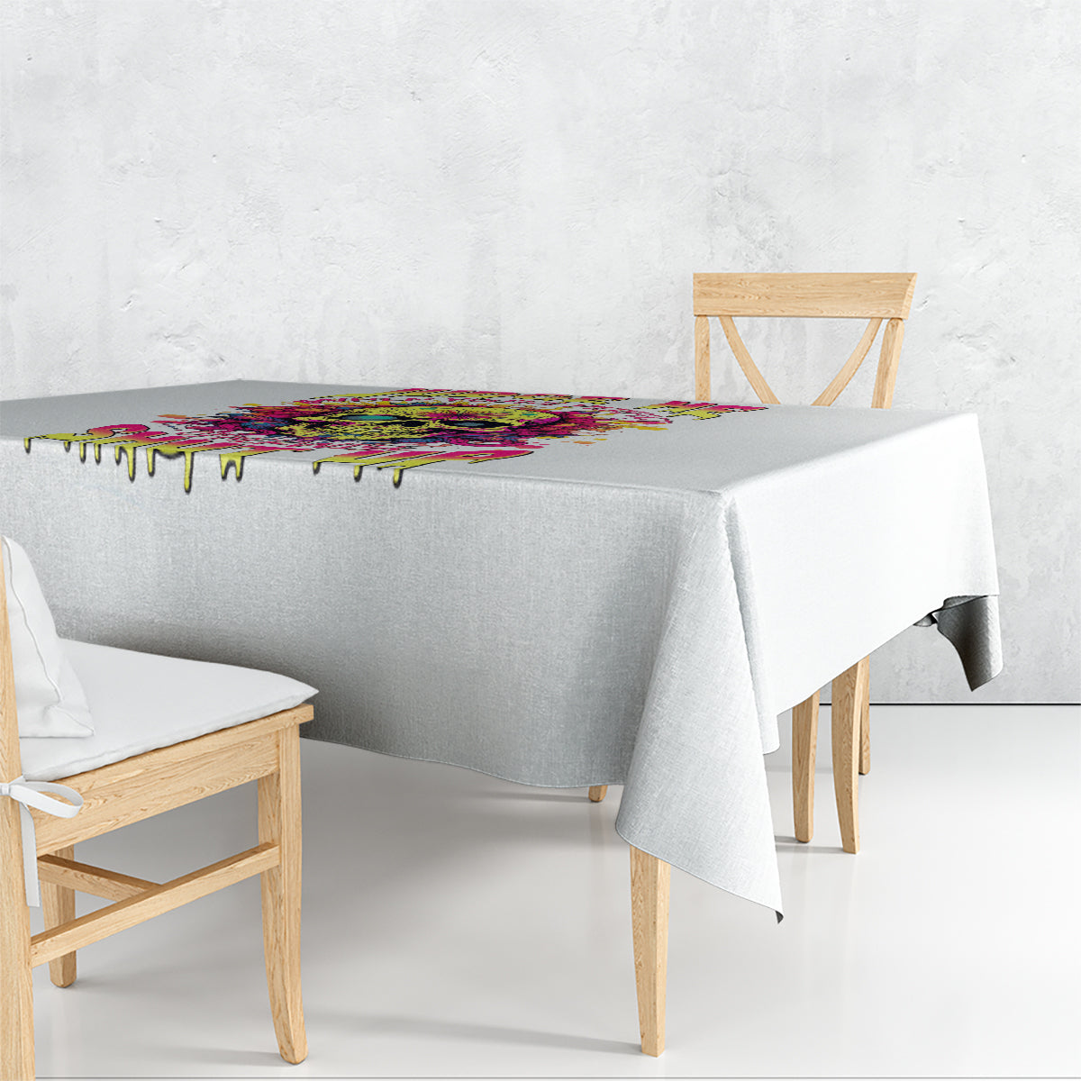 White tablecloth with multicolor dripping edge detail on a round table