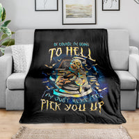 Black mummy skull graphic throw blanket with blue lightning and yellow lettering, folded on sofa