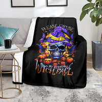 Black Halloween skull throw blanket with purple witch hat, pumpkins, and orange lettering
