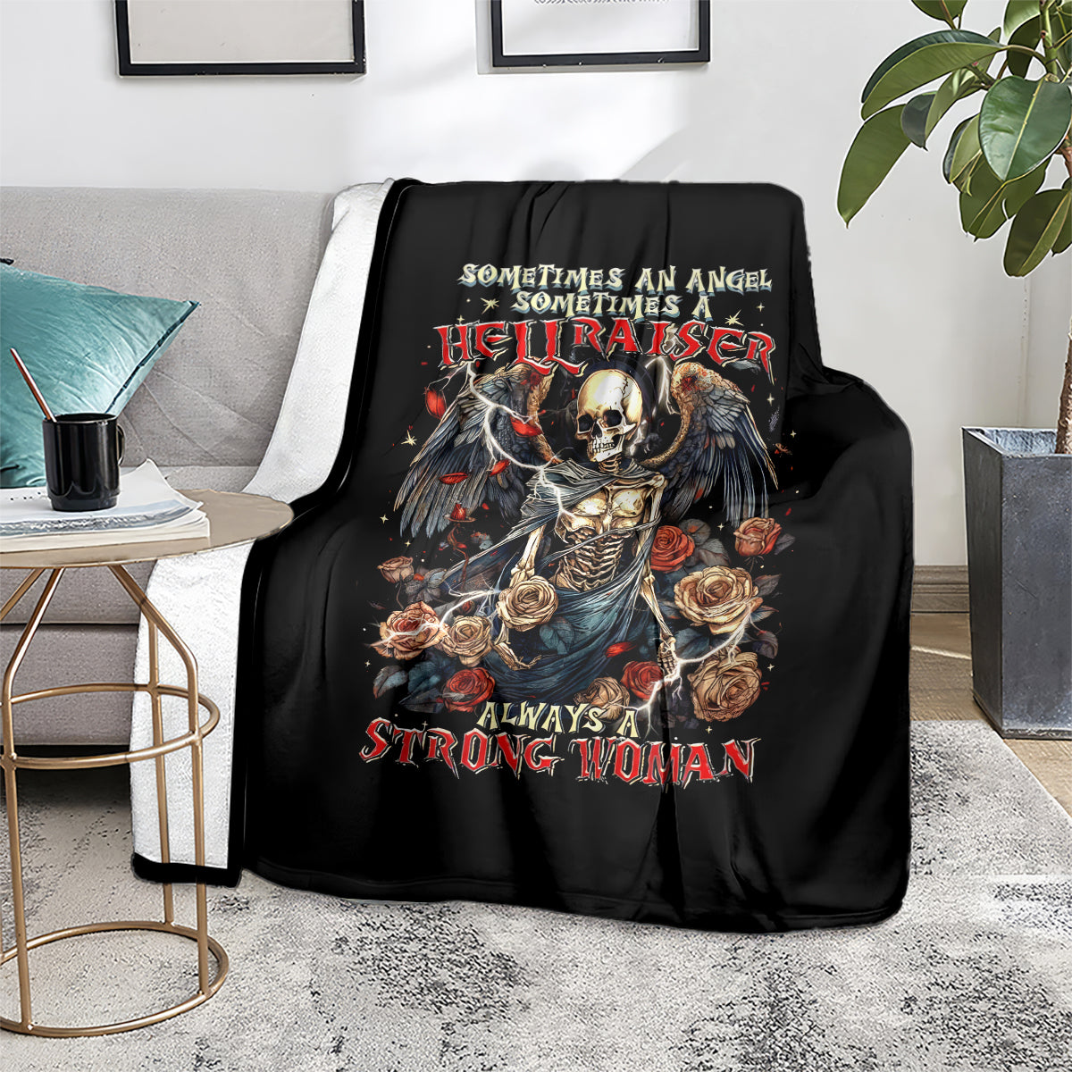 Black throw blanket with skull-and-angel rose design, smooth fabric drape