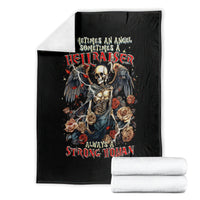 Black blanket with angel skull, wings, and rose graphic, folded with rolled bundle