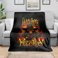 Black witch skull blanket with fiery hat and monster flame graphic, draped on sofa