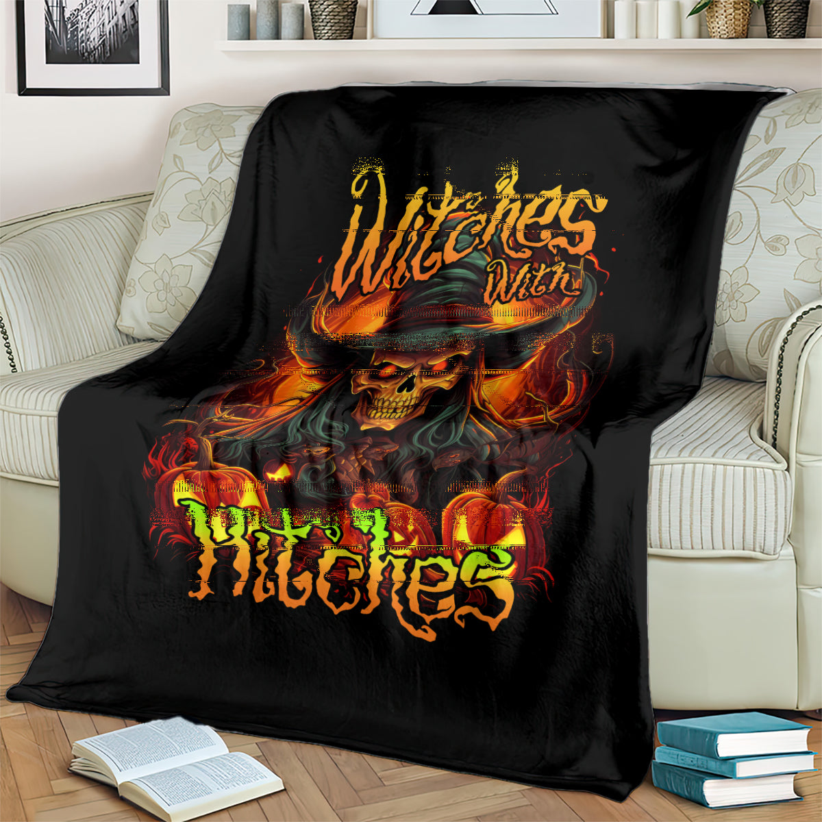 Black witch skull blanket draped over sofa with fiery skull hat and green flame text
