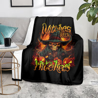 Black witch skull blanket spread on couch with glowing skull, orange flames, and text