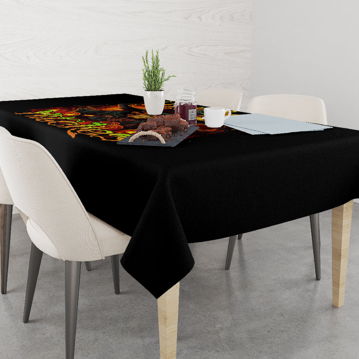 Black witch skull tablecloth draped over dining table with fiery scene print