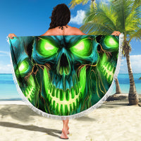 Round beach blanket held open, featuring glowing green-blue skull graphic and white fringe