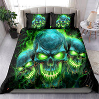 Black skull bedding set with neon green-blue flame skull artwork; on bed with two pillows