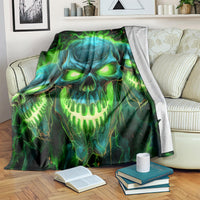 Skull flame graphic blanket, vivid green and blue glowing eyes, draped on sofa