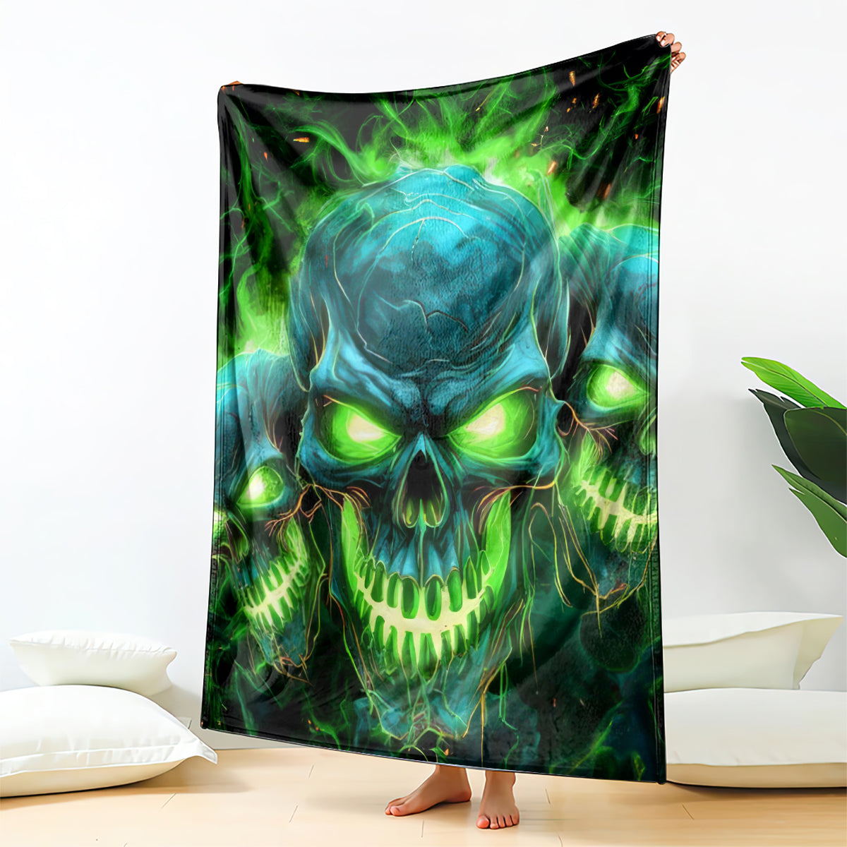 Skull flame graphic blanket, front view with glowing green eyes and teal skull design