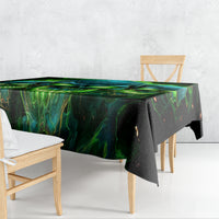 Black tablecloth with green-blue skull artwork draped over table corners