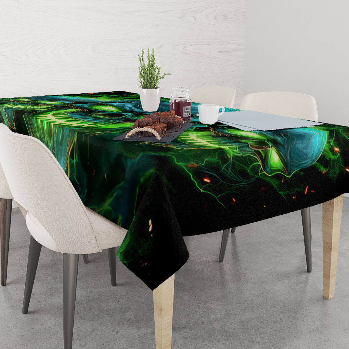 Black tablecloth with green-blue skull print, draped over dining table
