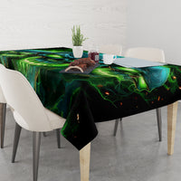 Black tablecloth with green-blue skull print, draped over dining table
