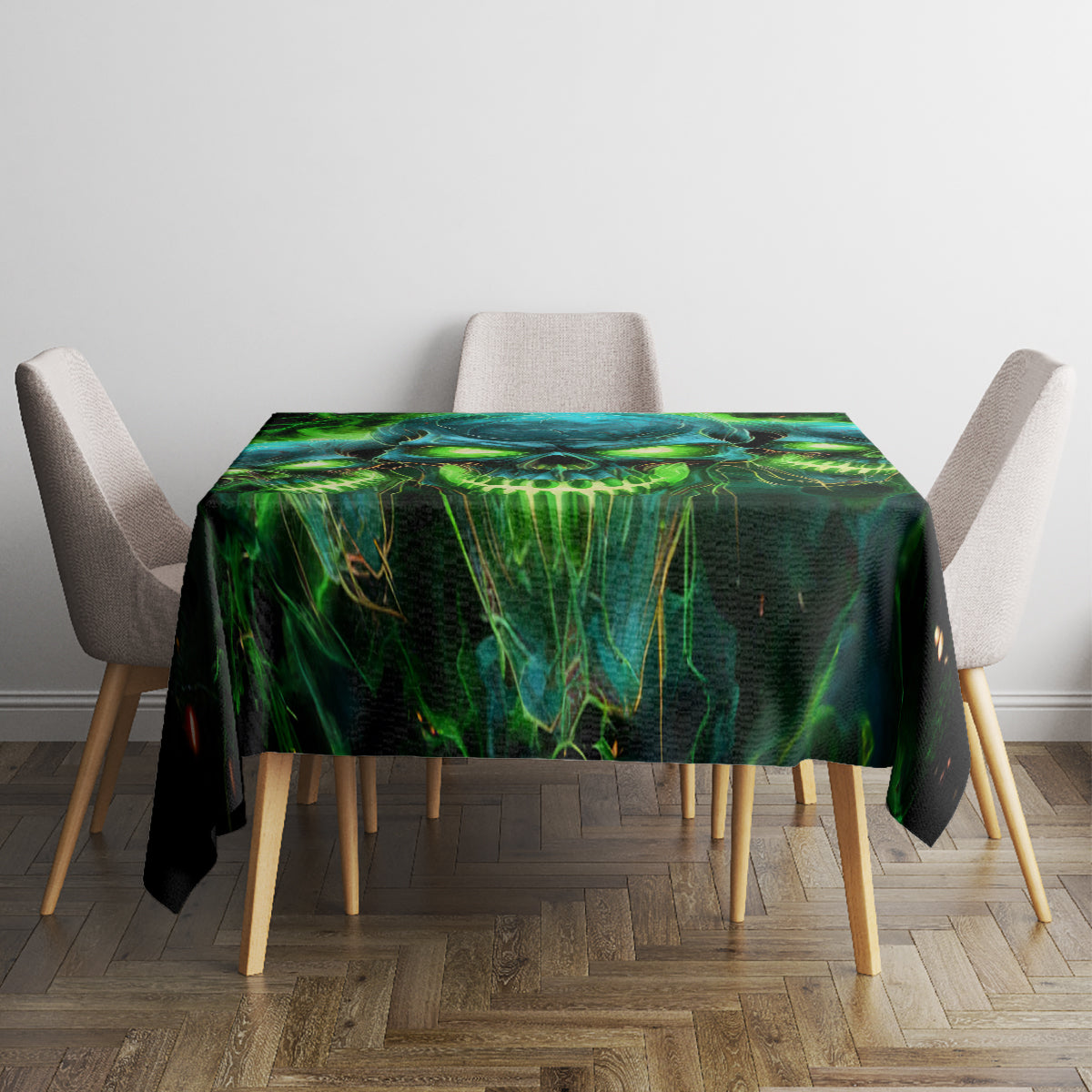 Black tablecloth with green-blue skull graphic covering square dining table
