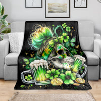 Black throw blanket draped on sofa with skull, rainbow hair, clovers, and coins print