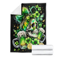 Black throw blanket folded with skull, rainbow hair, green clovers, and drink can print