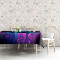 Black tablecloth with purple and blue rose swirls and neon skull graphic across the table.