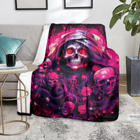 Skull rose blanket with neon pink skulls and roses, laid over chair