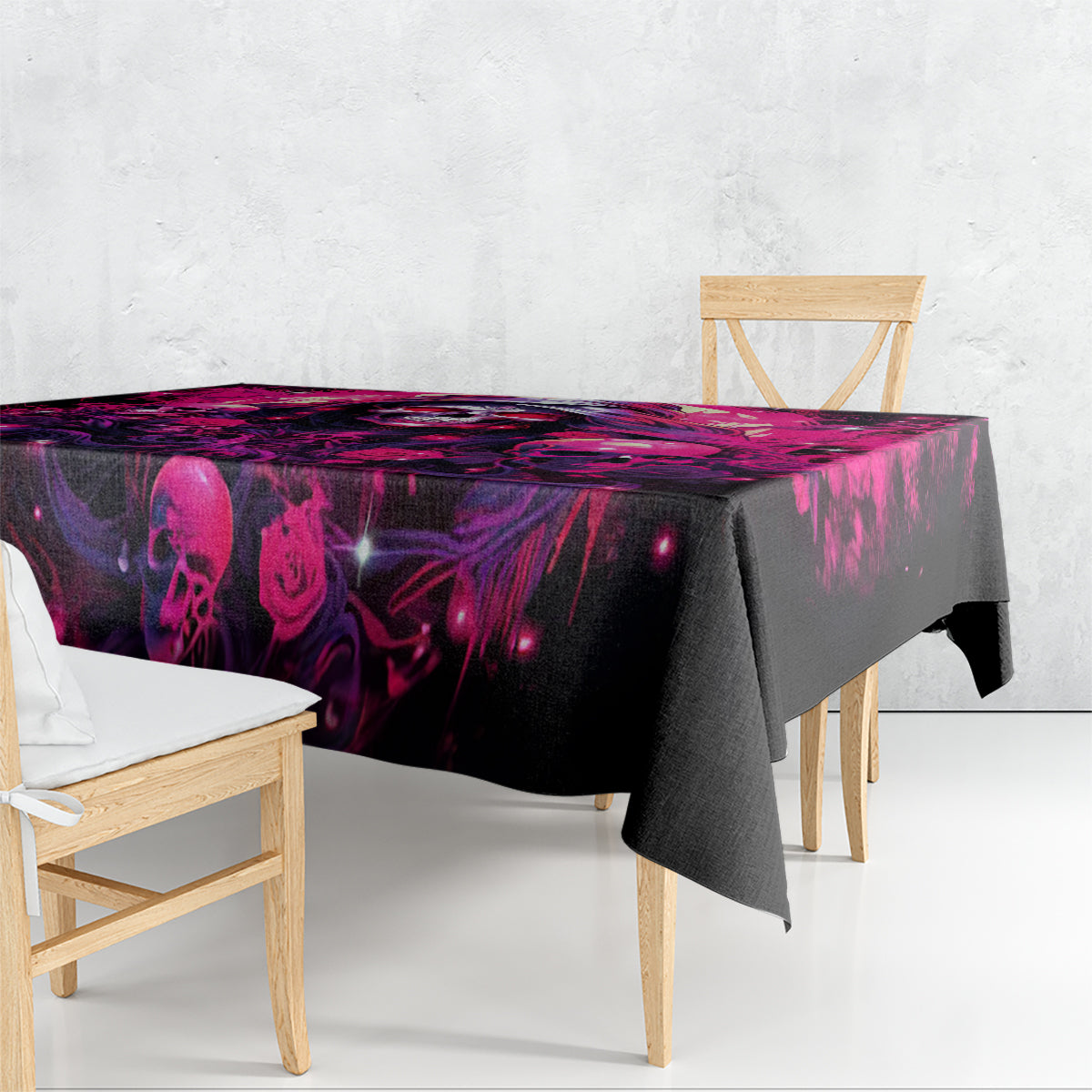 Rectangular tablecloth draped on table with dark skull and magenta rose print