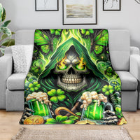 Green skull and clover beer bottles themed blanket draped on gray sofa seat