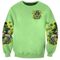 Green crewneck sweatshirt with small chest skull graphic and printed shamrock sleeves